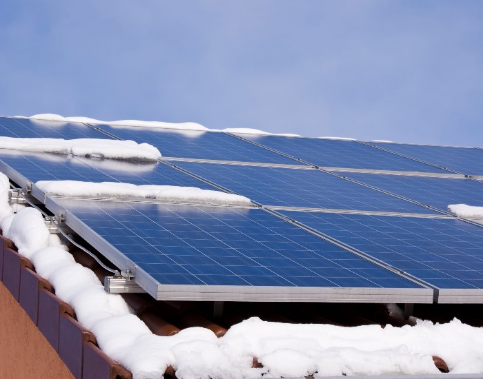 Solar panels installed by Kapital Electric in Chicago, IL, covered in snow during winter