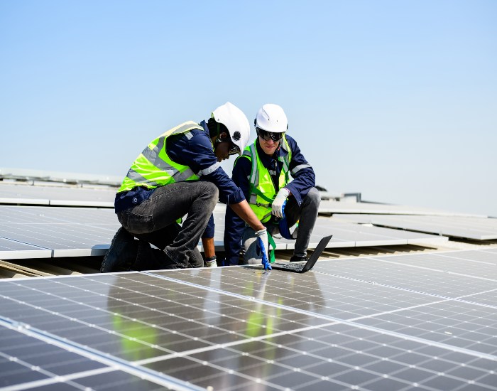 Team members from Kapital Electric, Inc. in Chicago, IL, are installing a solar system